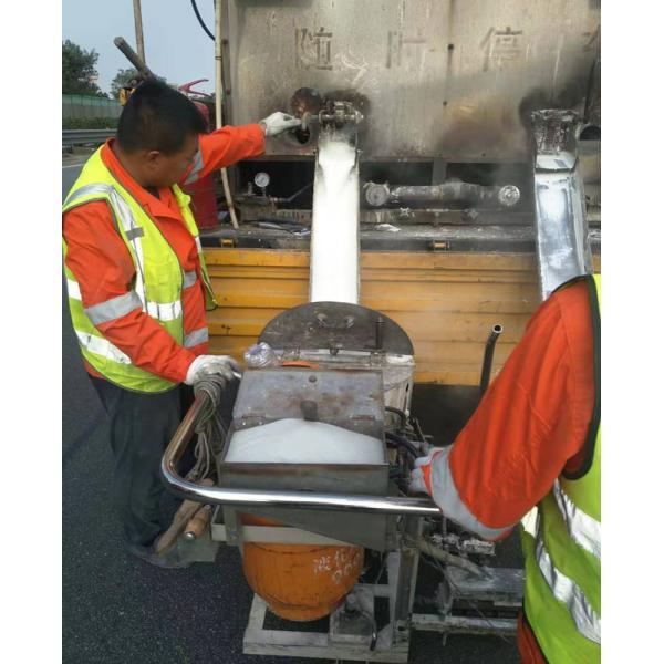 White thermoplastic road marking paint application on highway