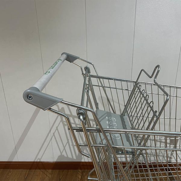 Close-up of shopping trolley handle and basket