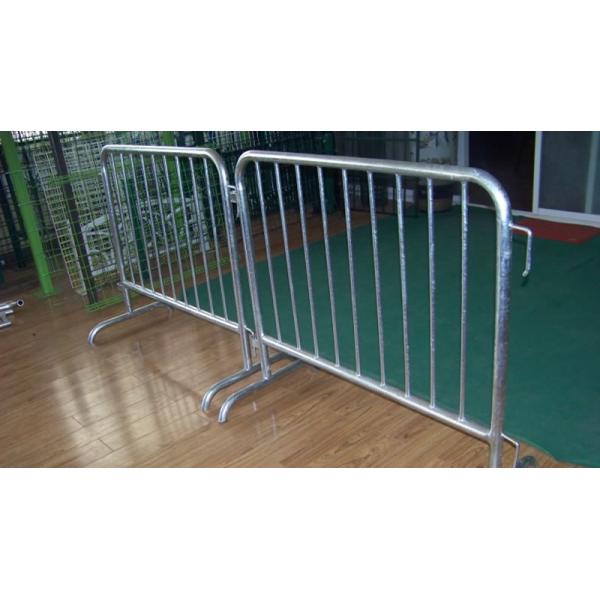 Two crowd control barriers with bridge feet are standing on the floor.