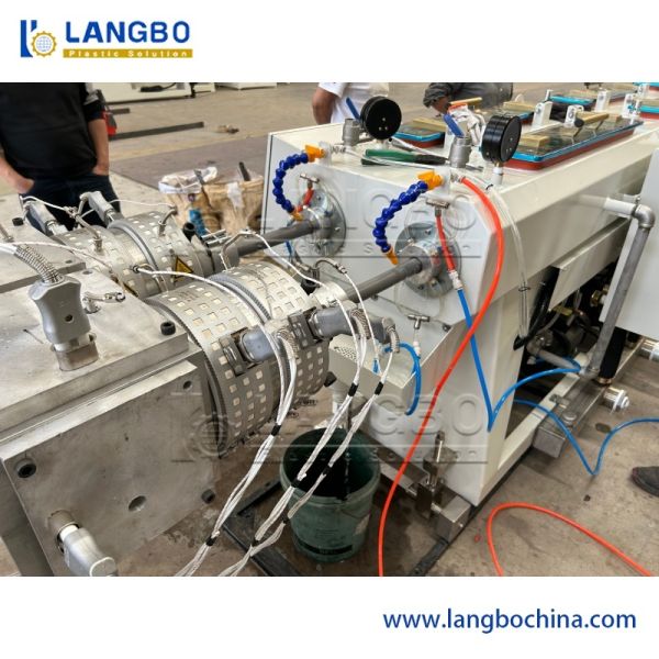 Close-up view of twin-screw extruder machine components